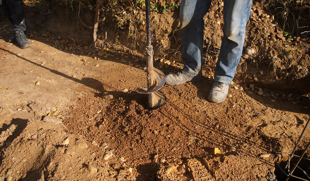 Soil pit excavation showing soil layers during engineered septic soil analysis